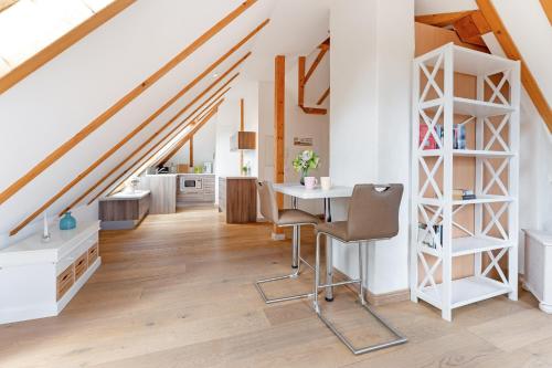 a kitchen and dining room with a table in a loft at Möwennest in Vitzdorf