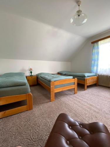 a room with two beds and a window at Retro chalupa Sobkovice in Sobkovice