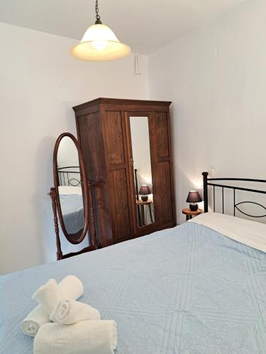 a bedroom with a bed with two folded towels on it at Levanta Apartment in Kythira