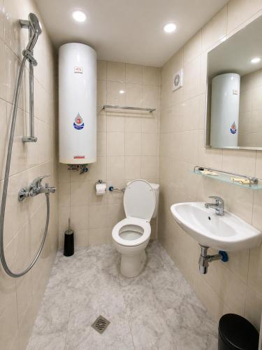 a bathroom with a toilet and a sink at Family Hotel Yulian in Kranevo
