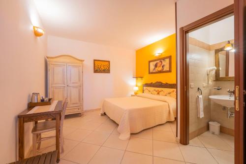 a hotel room with a bed and a sink at Sole del Mediterraneo in Otranto