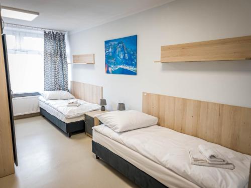 a room with two beds and a window at Dom Sportowca in Krosno