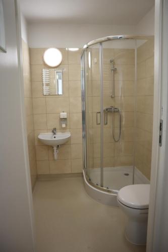 a bathroom with a shower and a toilet and a sink at Dom Sportowca in Krosno