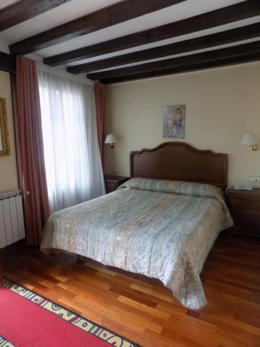 a bedroom with a bed and a large window at Itsasmin Ostatua in Elanchove