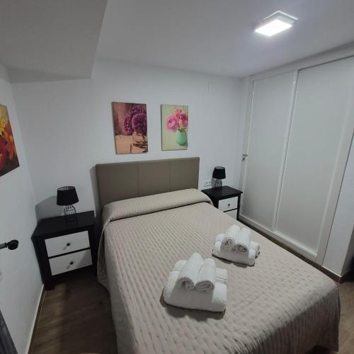 a bedroom with a bed with two towels on it at Puente del Rey in El Rocío