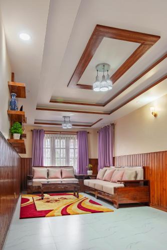 a living room with two couches and a rug at Comfort Apartment in Bālāju