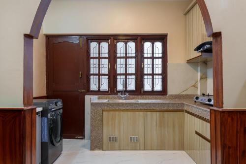 a kitchen with a sink and a dishwasher at Comfort Apartment in Bālāju