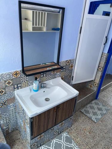 a bathroom with a sink and a mirror at Dar Besmellah in Chefchaouen