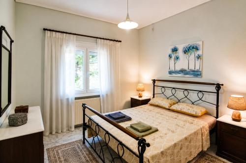 a bedroom with a bed and a window at Hill View 4 in Alexandroupoli