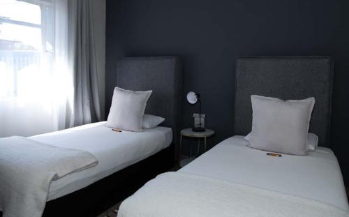 two beds sitting next to each other in a bedroom at Tubalala Properties in Rustenburg