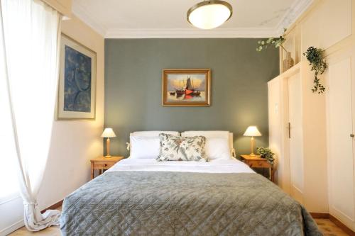 a bedroom with a large bed with two lamps at Art Gallery Hotel Athens in Athens