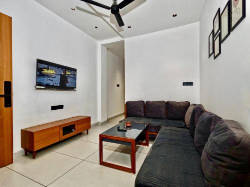a living room with a couch and a table at Spacious 2BHK Group Stay in Vijay Nagar, Indore in Indore