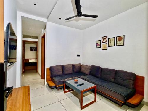 a living room with a couch and a table at Spacious 2BHK Group Stay in Vijay Nagar, Indore in Indore