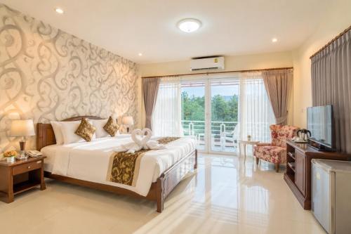 a hotel room with a bed and a television at Alisa Krabi Hotel-SHA Plus in Krabi