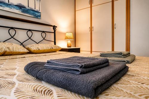 a bedroom with a bed with two towels on it at Hill View 4 in Alexandroupoli
