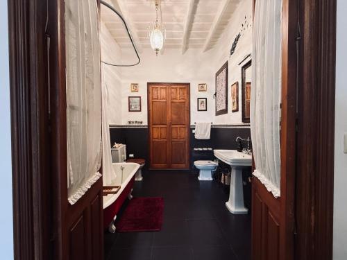 a bathroom with two sinks and a tub and a toilet at Benafique La casa del Ciprés - refugio de calma en la Sierra de Huelva in Cortegana