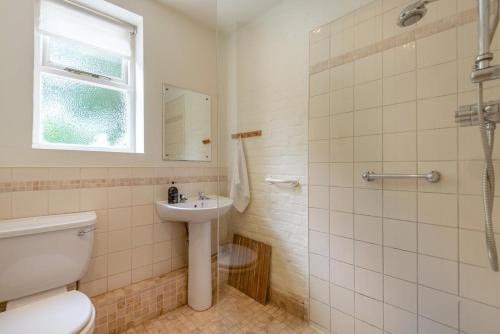 a bathroom with a toilet and a sink and a shower at 4 Bed in Lyndhurst oc-57407 in Lyndhurst