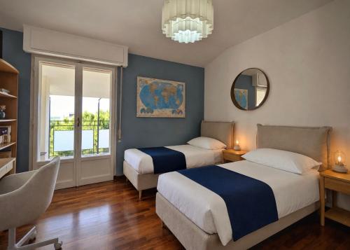 a bedroom with two beds and a chandelier at Greto al Mare in Francavilla al Mare