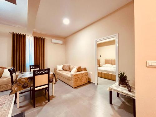 a living room with a table and a couch at Kristian apartments in Berat
