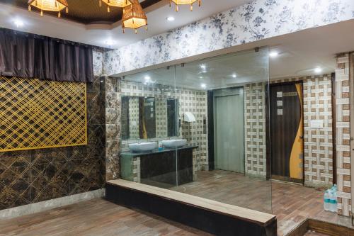 a bathroom with a glass shower and a sink at Hotel Ornate Residency And Suites in Gurgaon