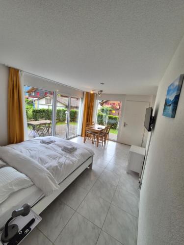a bedroom with a bed and a dining room with a table at Alpine Bliss Studio in Wilderswil