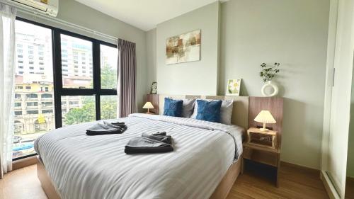 a bedroom with a large bed and a large window at Luxury Astra Sky River in Chiang Mai