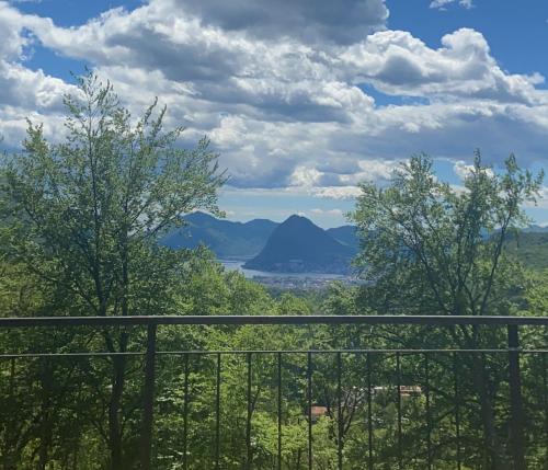 a view of a mountain from a balcony at Casa Cristina - Stunning Lake & Mountain View in Roveredo Capriasca