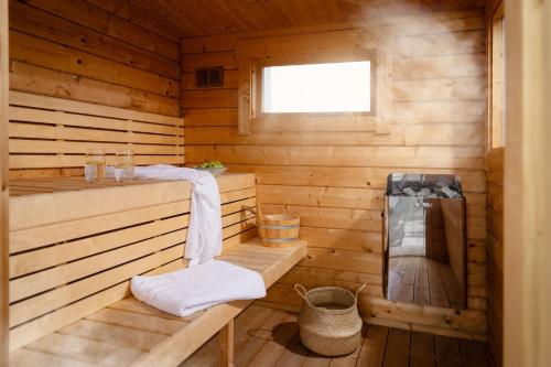 a sauna with a bench in a wooden cabin at Brennik House in Port Isaac