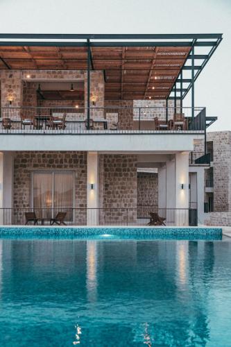 a house with a swimming pool in front of a building at Wadi Sabarah Lodge in Abu Dabbab