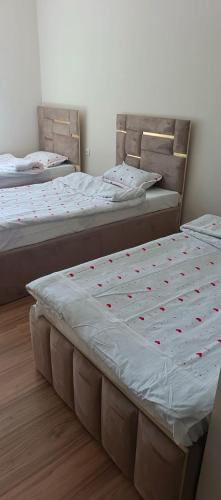 two beds in a room with red hearts on them at Eraj Bibi Fatima in Yamchin