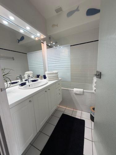 a white bathroom with a sink and a tub at Mimi lodge familly in Valloire