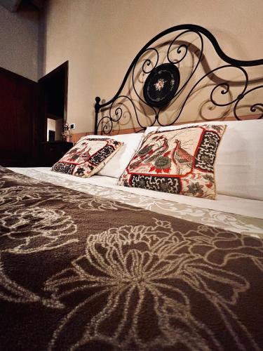 a bed with two pillows on it with a head board at Casa Amiata in Sarteano