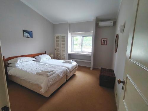 a bedroom with a bed and a window at Vale Do Lobo 935 in Loulé