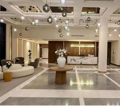 a lobby with a vase of flowers on a table at Seabreeze Baku White Residence Studio, Terrace in Baku