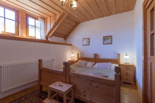 a bedroom with a large wooden bed in a room at Penzion Vinicky dvůr in Kaplice