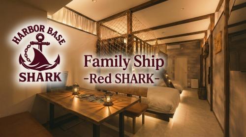 a bedroom with a sign for a family ship red shark at Harbor base SHARK in Sado