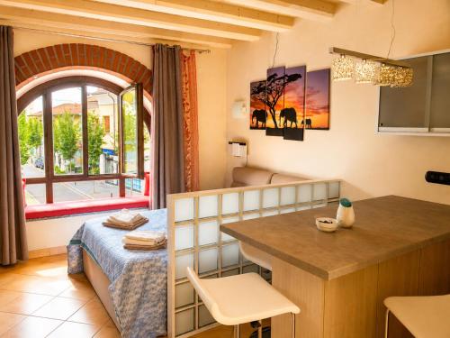 a room with a bed and a kitchen with a table at Corte del Centro Novate Milano in Novate Milanese