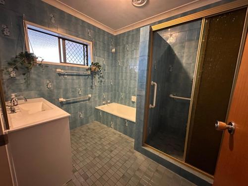 a bathroom with a shower and a sink at Casa Sarina in Stanthorpe