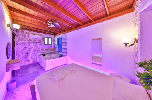 a large bathroom with a tub and a sink at Nergiz Villas in Kaş