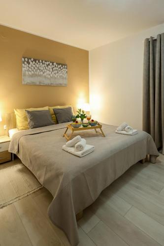 a bedroom with a large bed with two towels on it at Apartman Ruza 1 in Poljane