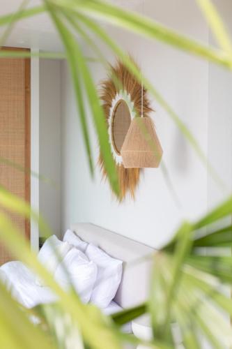 a mirror with a hat hanging on a wall at Siam Mila Villas in Srithanu