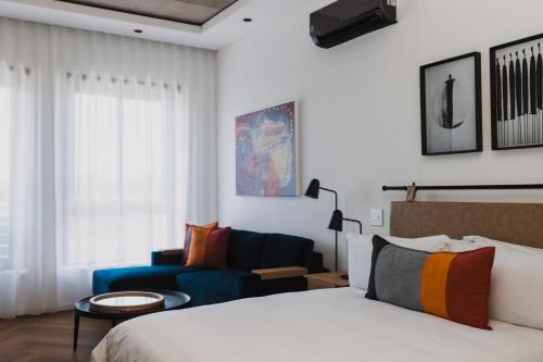 a hotel room with a bed and a couch at Century City Hotel Bridgewater in Cape Town