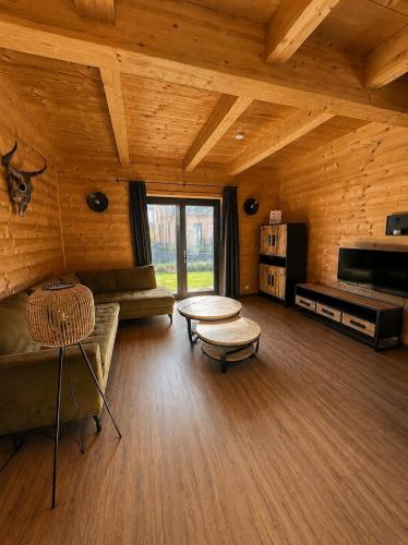 a living room with a couch and a table at Nassfeld Chalet in Rattendorf