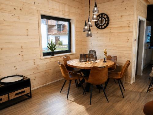 a dining room with a table and chairs at Nassfeld Chalet in Rattendorf
