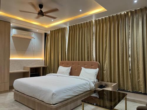 a bedroom with a bed and a ceiling fan at The Barrel House, Varanasi in Varanasi