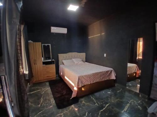 a bedroom with a bed and a television in it at Casa Vale do Sal 2 in Salinópolis