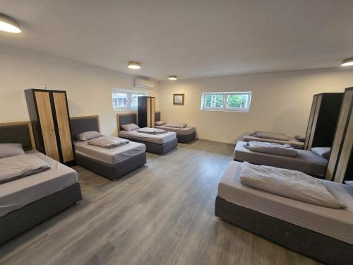 a room with four beds and couches in it at Hostel P16 in Zagreb