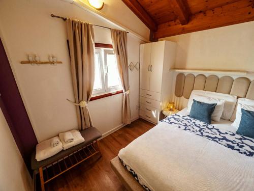 a bedroom with a large bed and a window at ILOVIK FLOWER in Ilovik