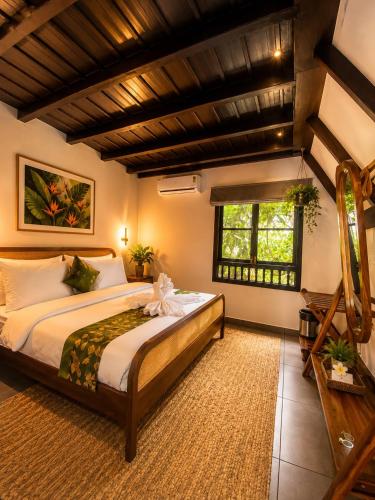 a bedroom with a large bed in a room at DZION Resort Coorg in Gonikoppal