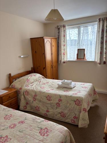a bedroom with two beds and a window at Ashley Court Hotel in Torquay